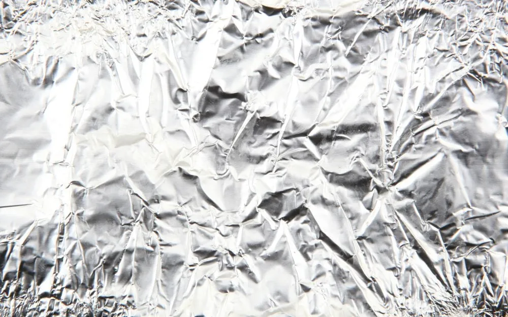 Scrunched shiny aluminium foil surface